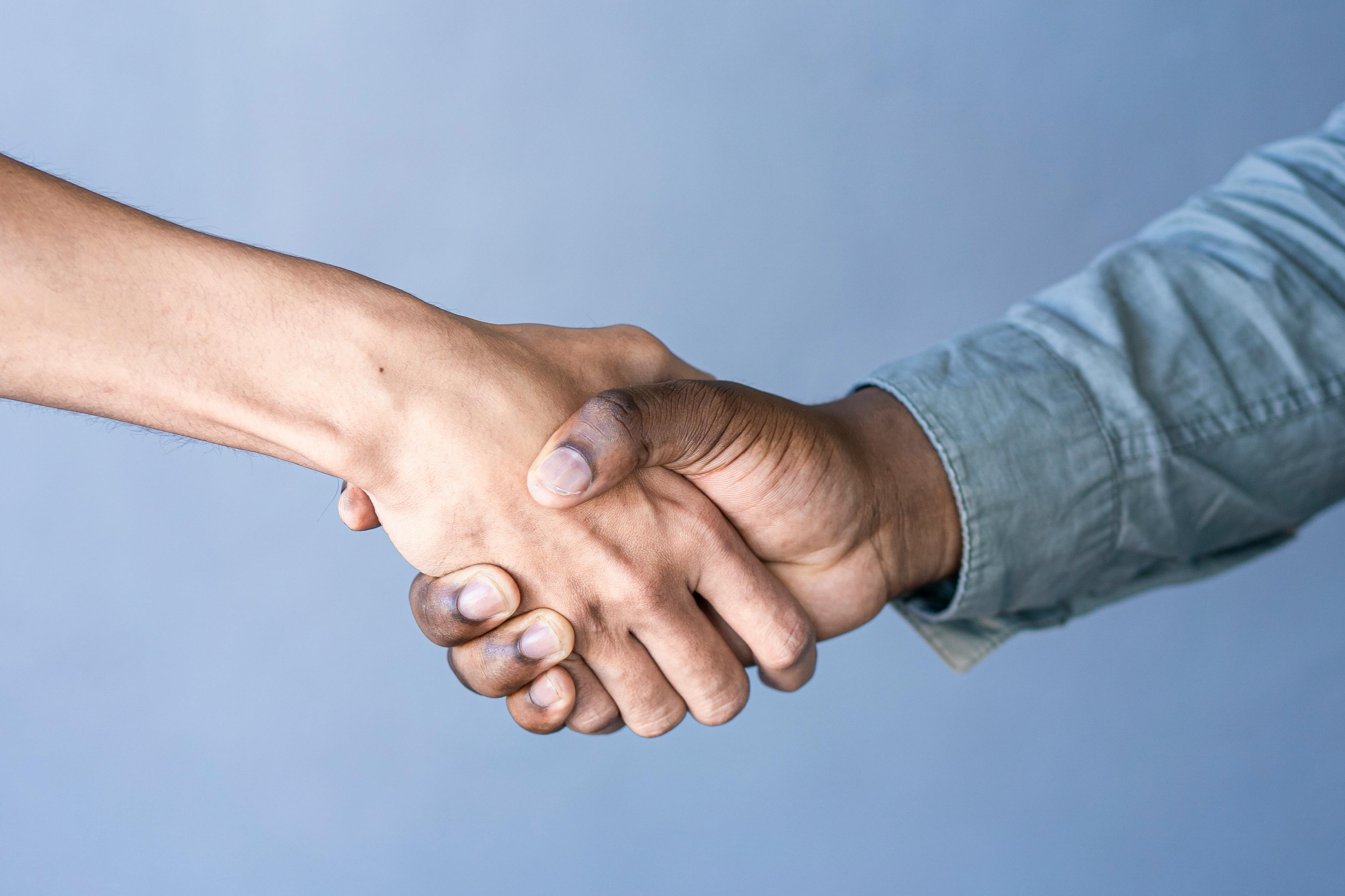 Close%20up%20shot%20of%20a%20friendly,%20professional%20handshake Close-up shot of a friendly, professional handshake